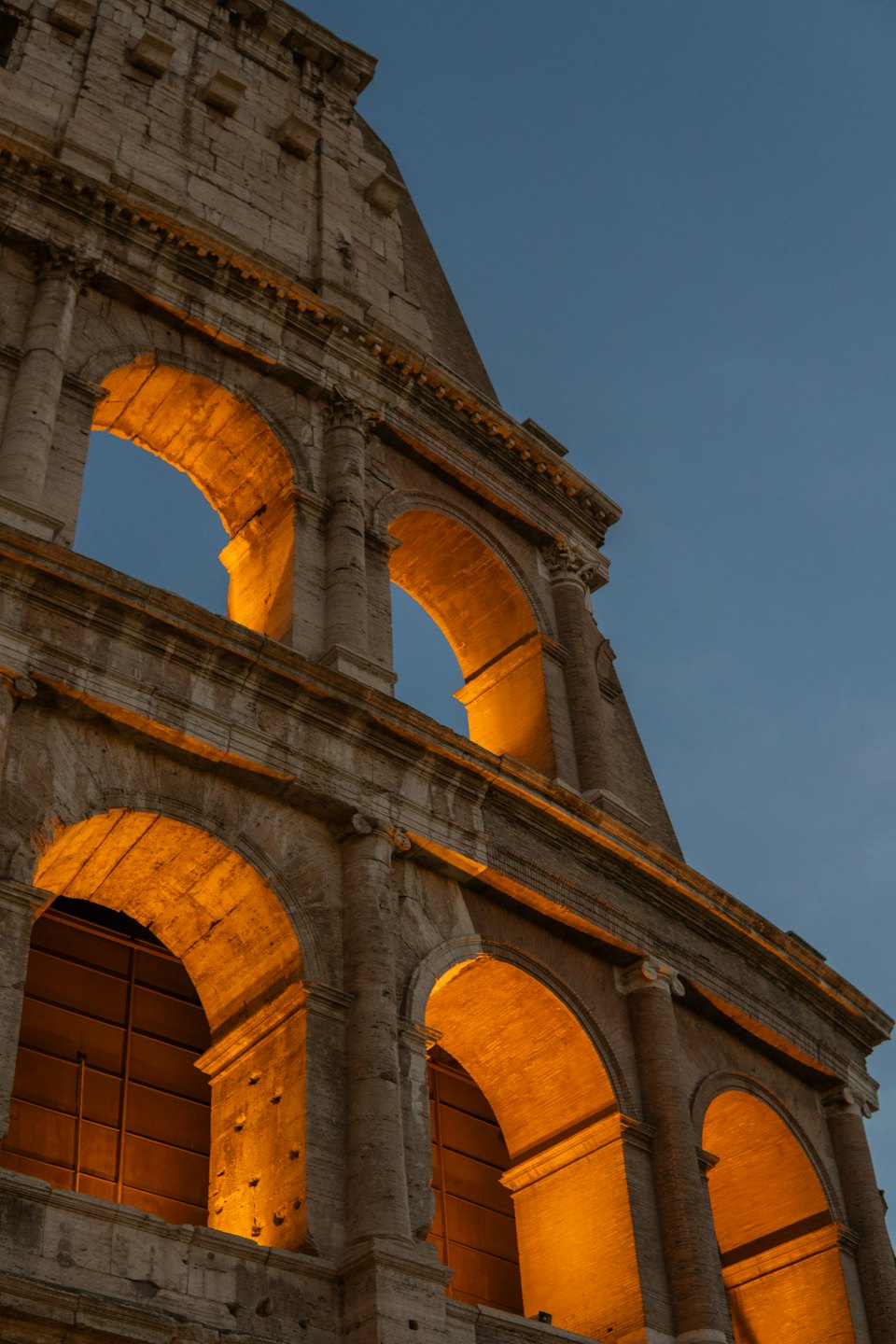 Il Colosseo romano antico illuminato al tramonto.